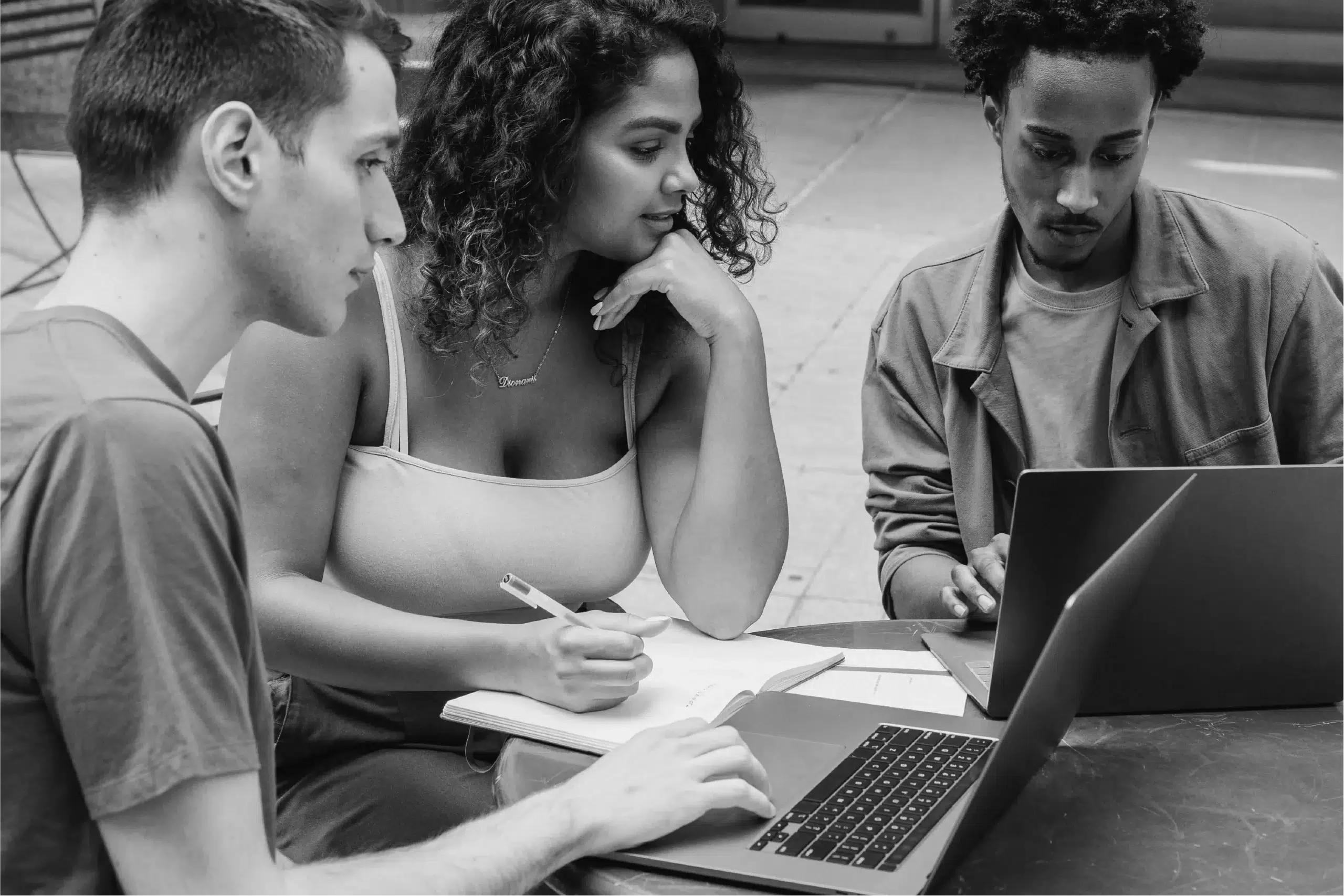 Researchers reviewing a study together on a laptop