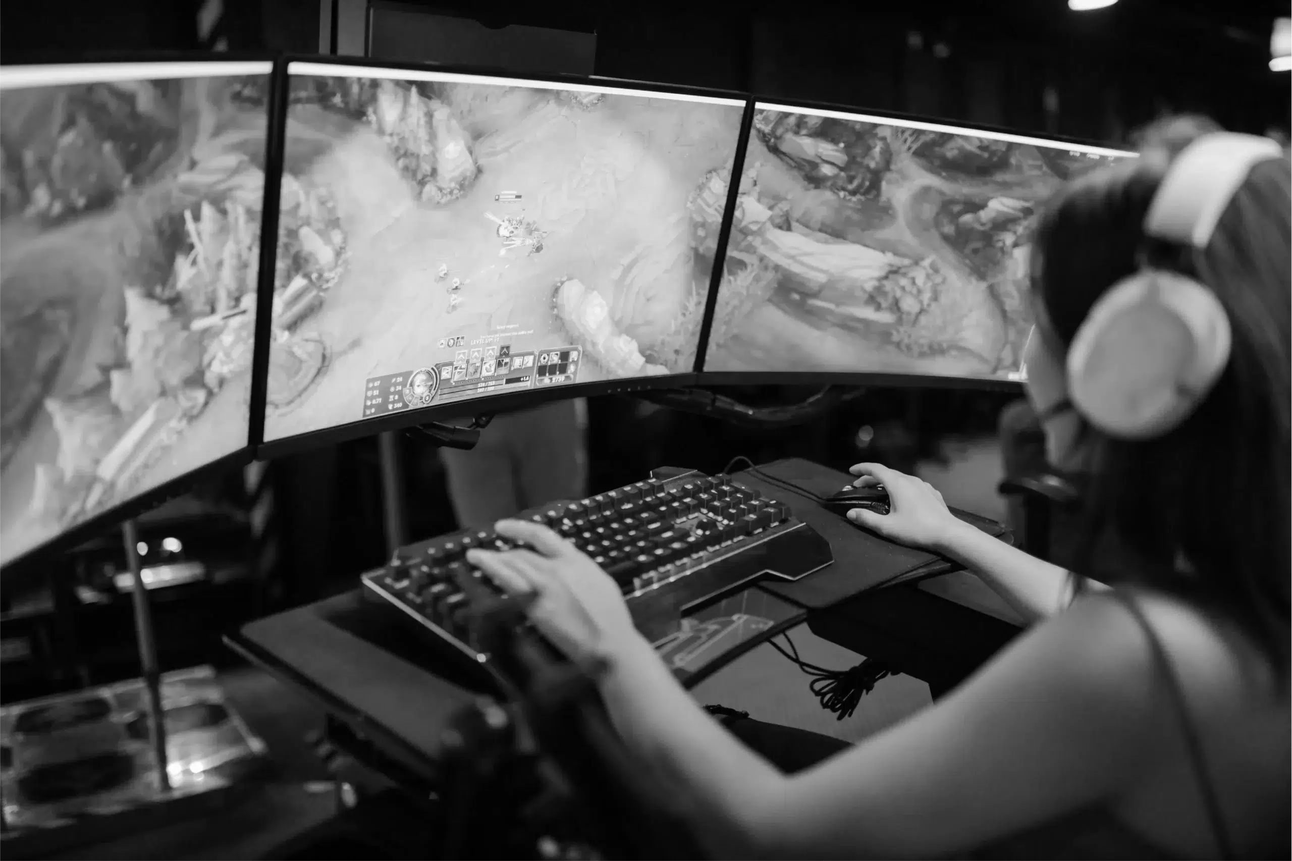 Person playing a video game on large monitors